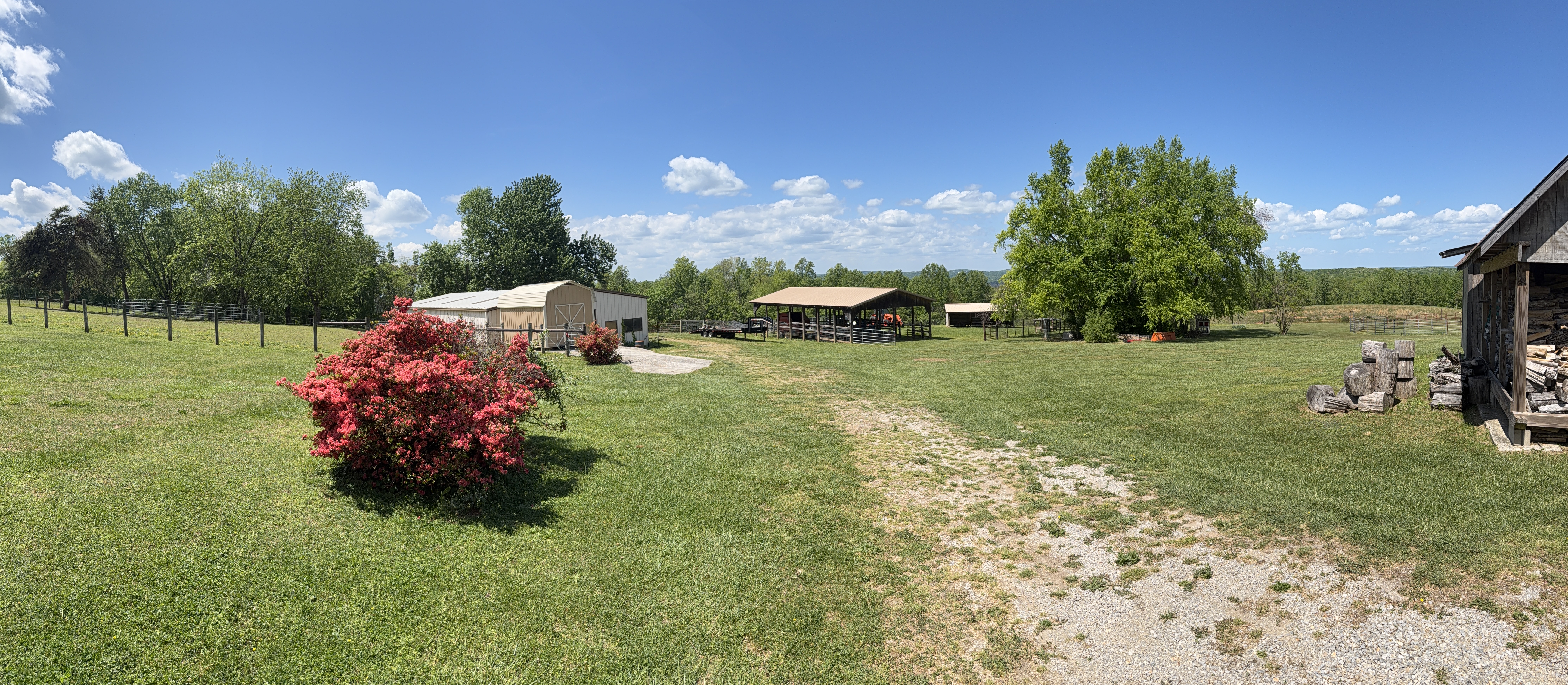 Farm road with barn structures and open field