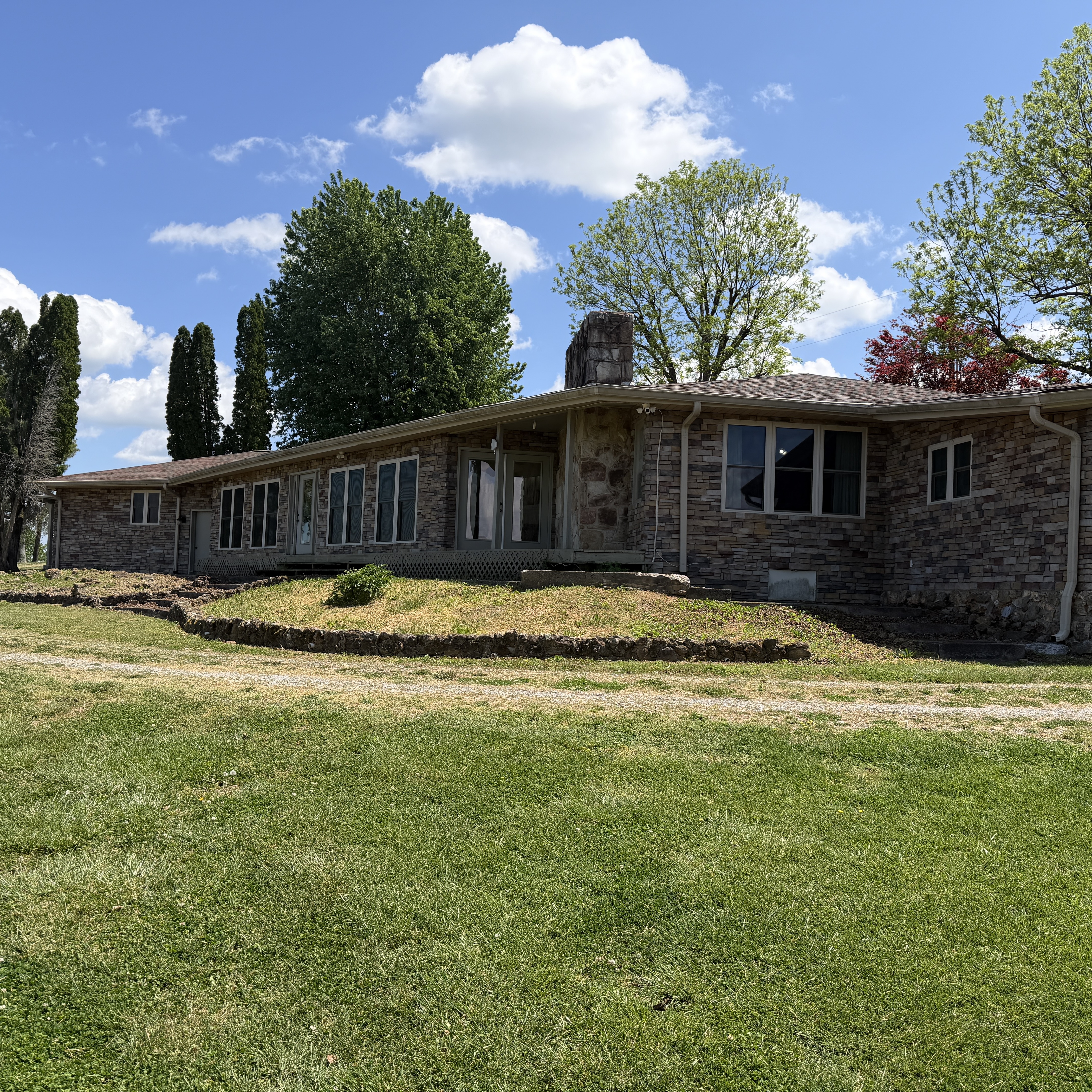 Stone home close-up with spring greenery